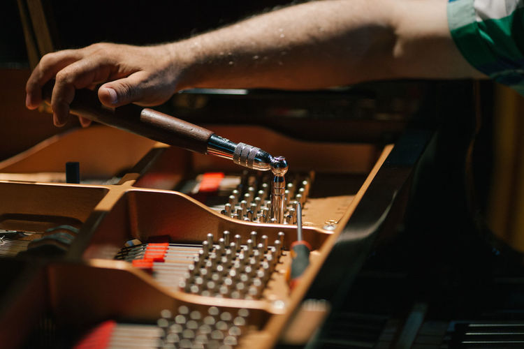 Cropped image of hand working on piano