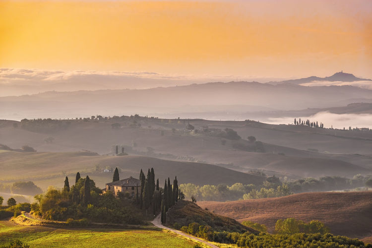 The iconic agriturismo podere belvedere in tuscany at sunrise.