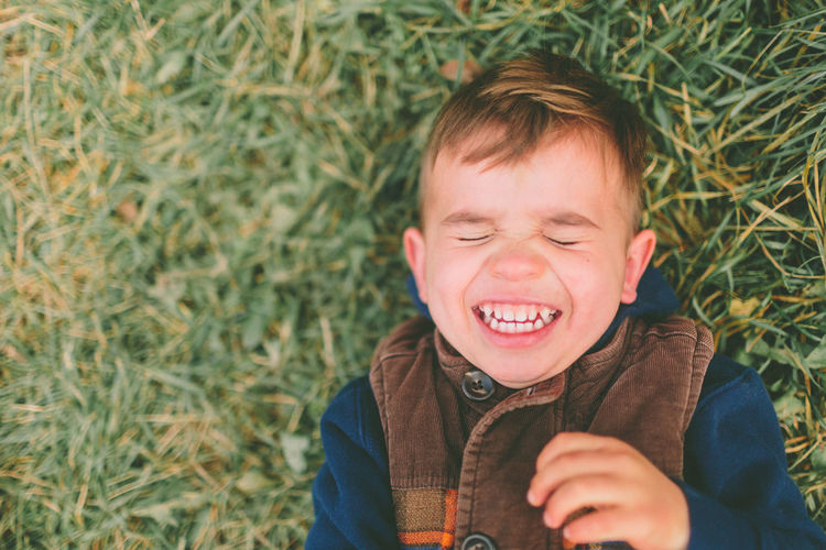 Smiling boy lying down on field