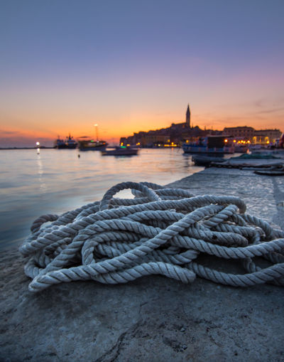 Close-up of rope tied on boat at sunset