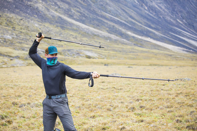 Hiker adds humor to a backpacking trip, using poles as swords