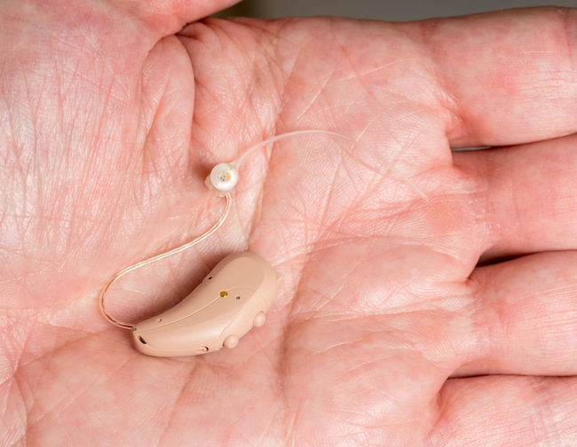 Close-up of hearing aid in hand
