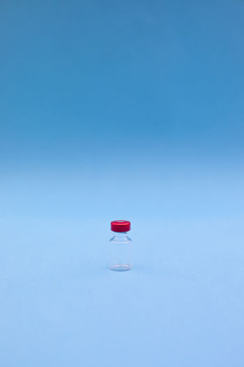 Red umbrella against blue background