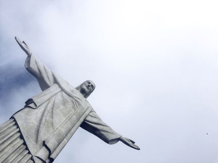 Low angle view of jesus christ statue against sky