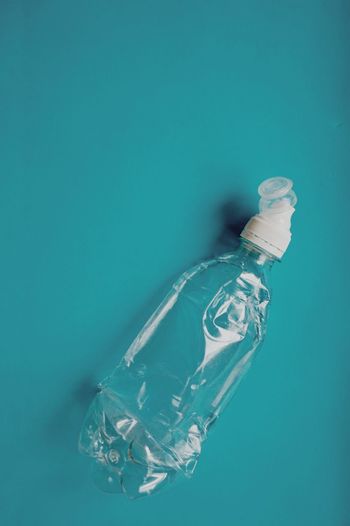 High angle view of bottle on table against blue background