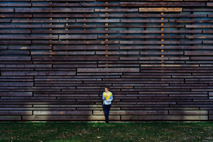 Woman standing against wall