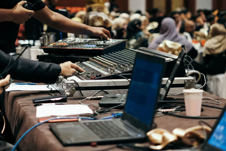 Close-up of audio equipment with people during seminar