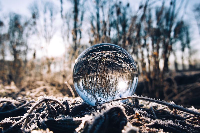 Close-up of crystal ball on frozen field