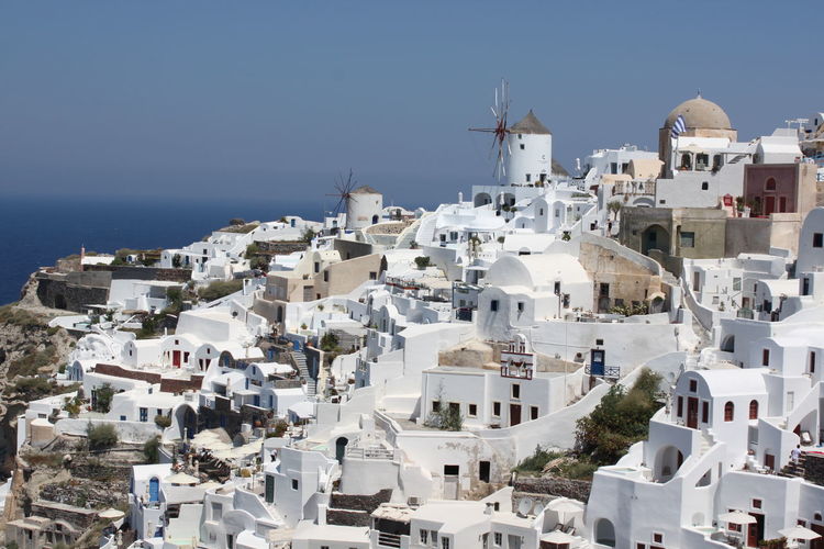 Buildings in city against clear sky
