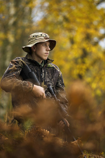 Teenage boy with rifle at hunting