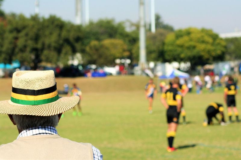 Rear view of people on rugby field
