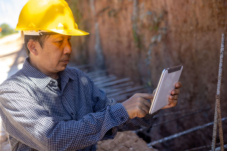 Midsection of man working with mobile phone