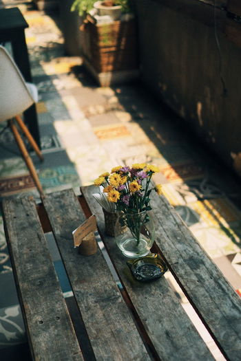 High angle view of flowers in vase on table at cafe
