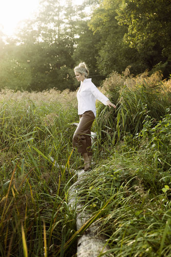 Full length of girl walking on field