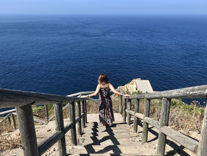 Rear view of woman looking at sea