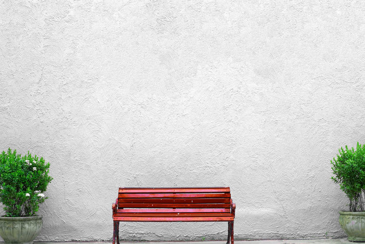 Red chairs against plants