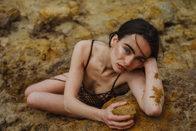 Young woman holding sand