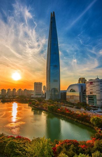 View of city at waterfront during sunset