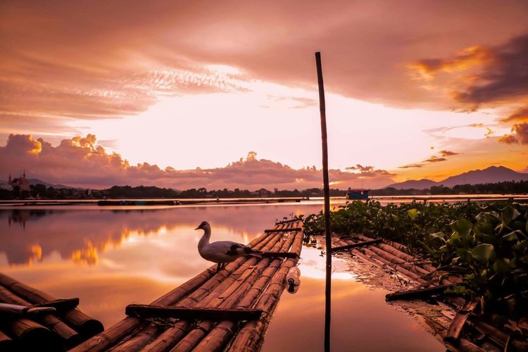 Scenic view of lake against sky during sunset