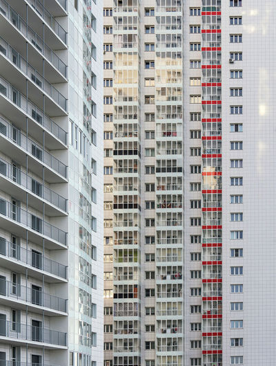 A large number of windows and balconies on building facade. apartment block. residential building