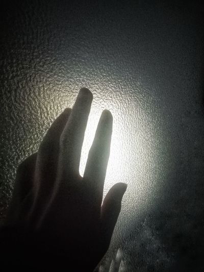 Shadow of person hand on wall