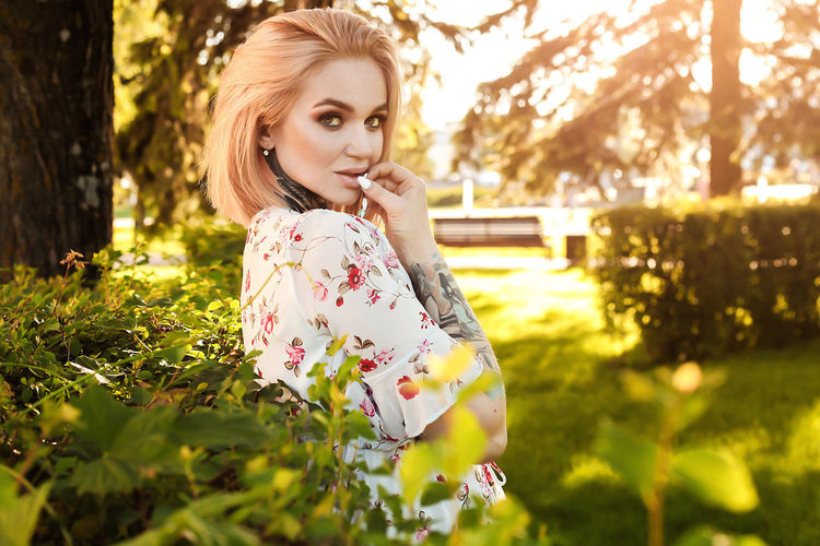 Portrait of woman against plants