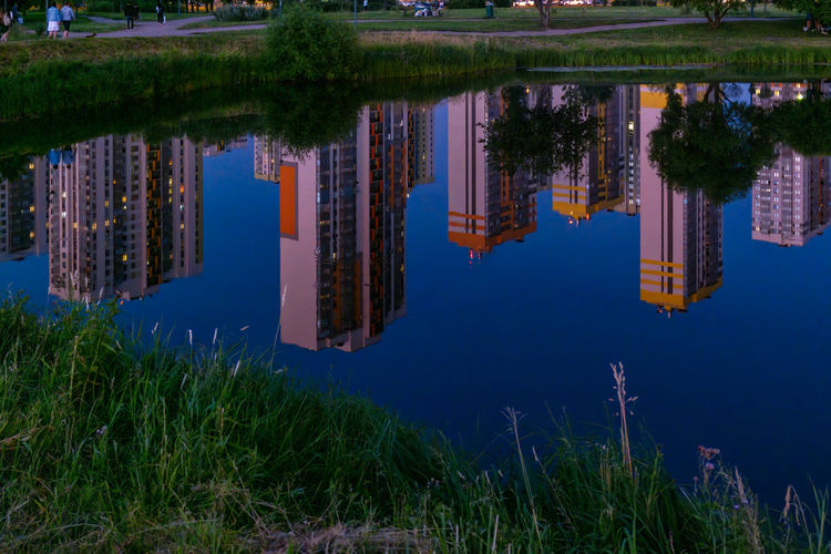Reflection of trees and buildings in lake