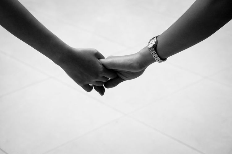 Close-up of couple holding hands