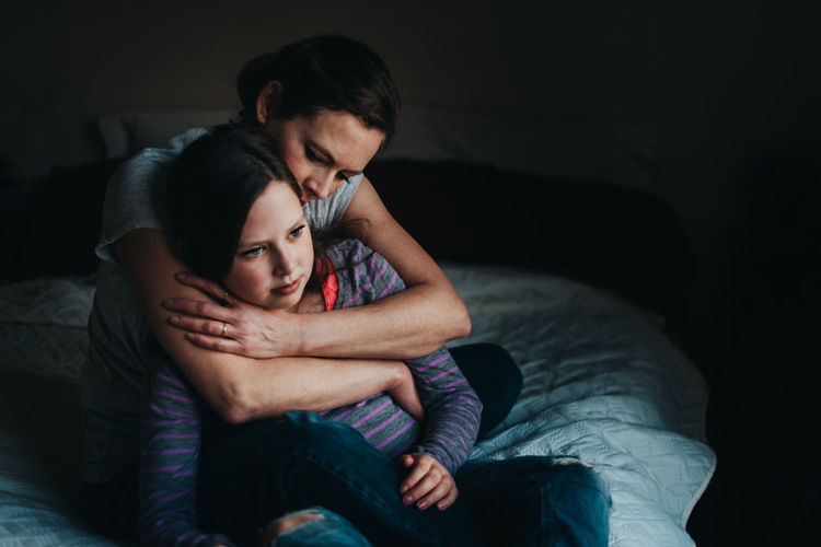 Adult Bed Bonding Couple - Relationship Day Embracing Heterosexual Couple Home Interior Indoors Lifestyles Love People Real People Relationship Difficulties Sitting Togetherness Two People Women Young Adult Young Women