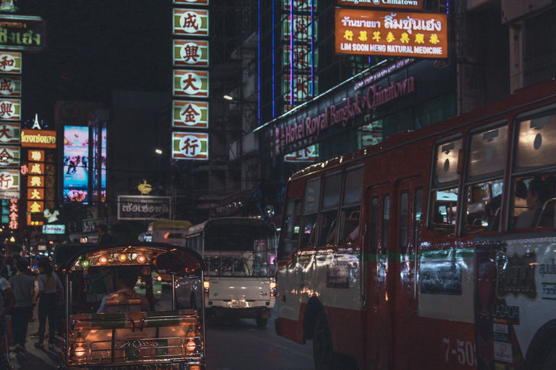 Buses on road in city at night