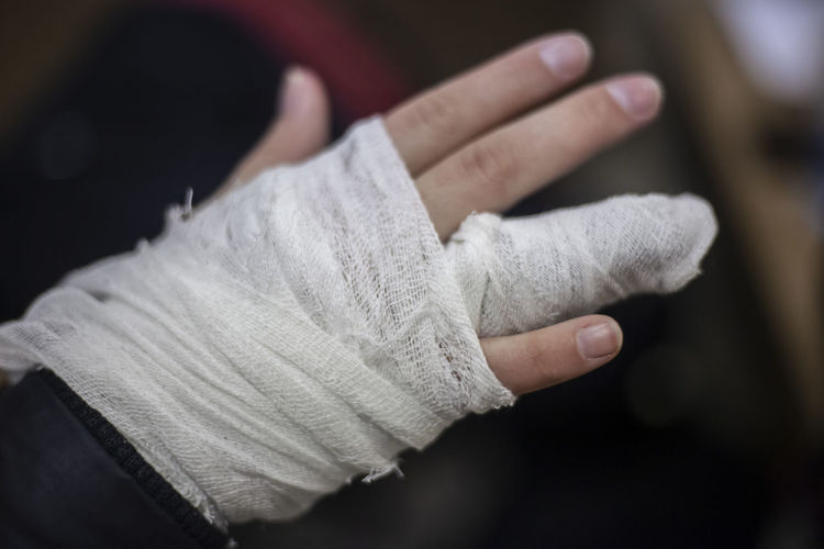 Cropped hands of person with medical equipment and bandage