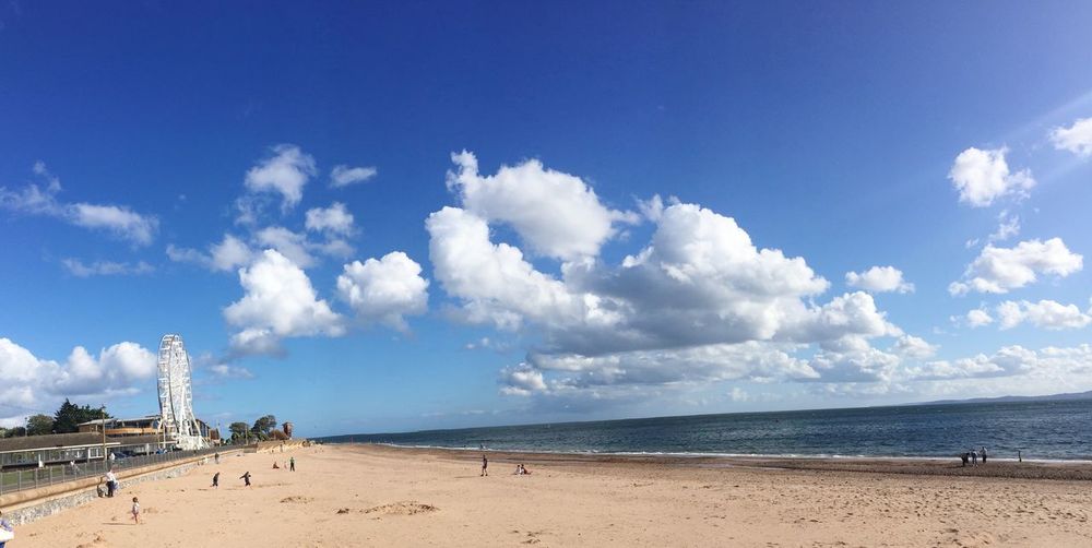 Panoramic view of beach against cloudy sky