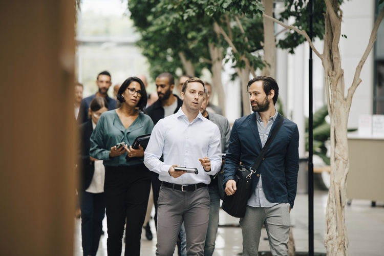 Male and female entrepreneurs walking outside office