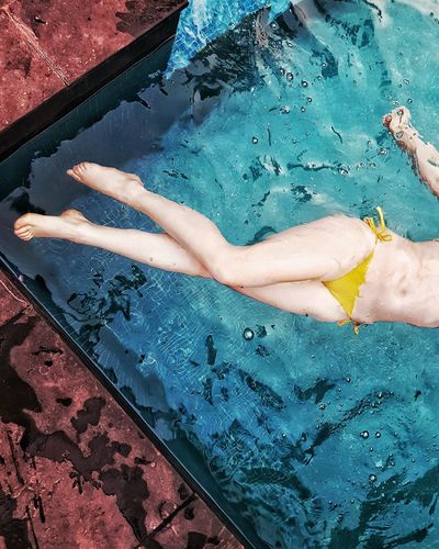 Low section of a woman in swimming pool
