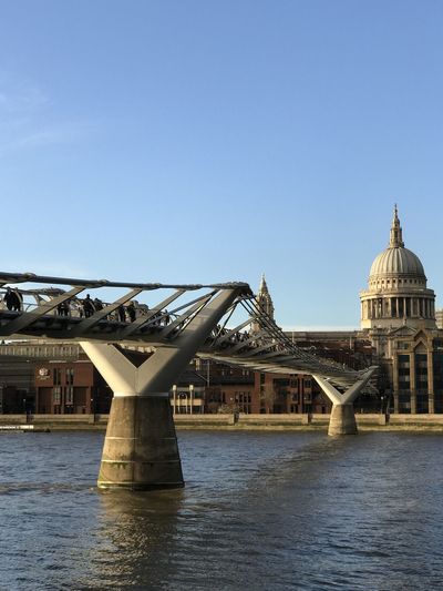 Bridge over river against buildings