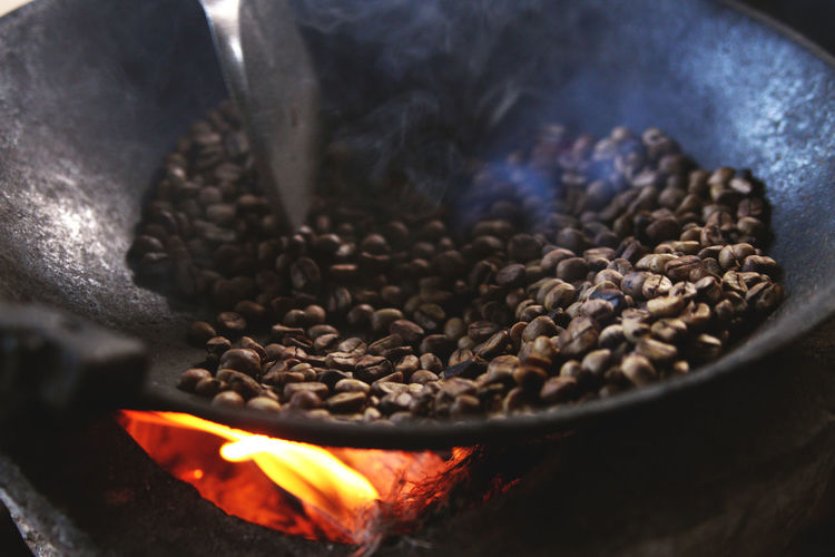 Close-up of coffee beans being roasted in pan