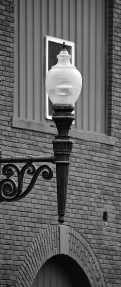 Low angle view of street light against wall