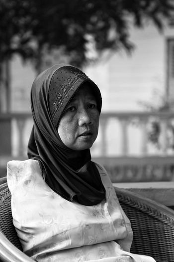 Disabled mature woman sitting on wicker chair
