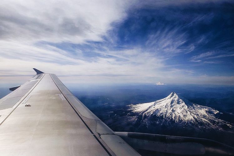 Scenic view of mountains against cloudy sky