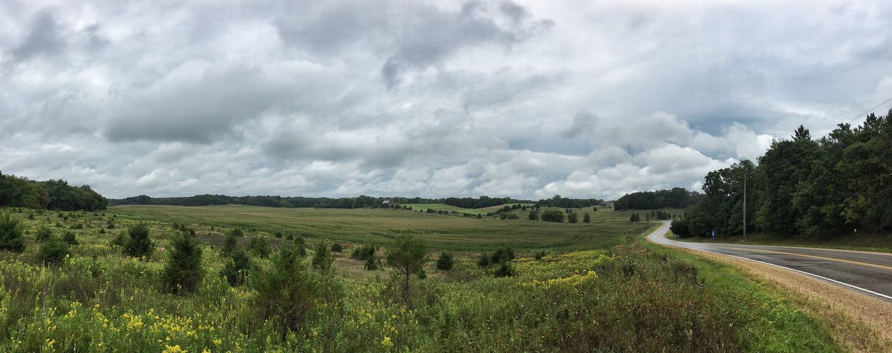 Panoramic shot of country road along landscape