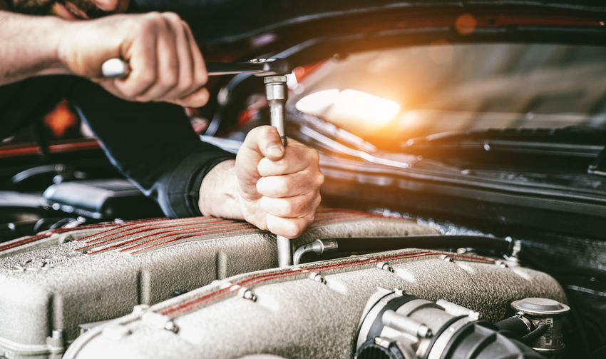 Mechanic repairing car engine