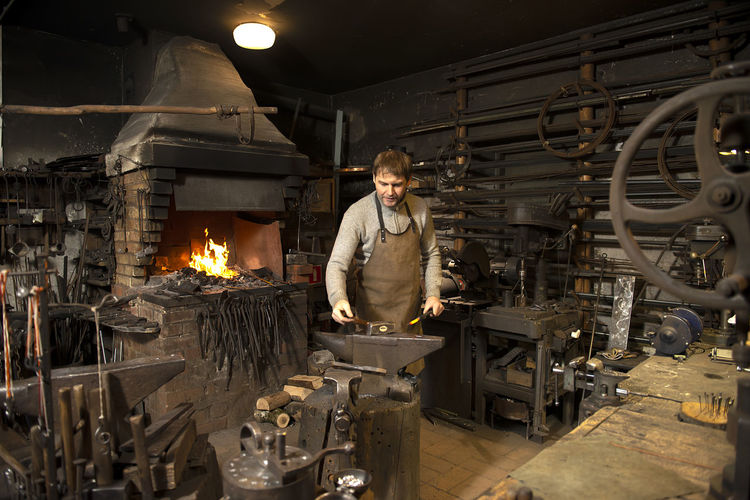 Blacksmith working in workshop