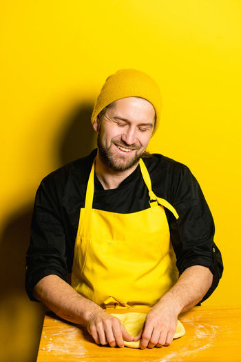 Chef preparing food against colored background