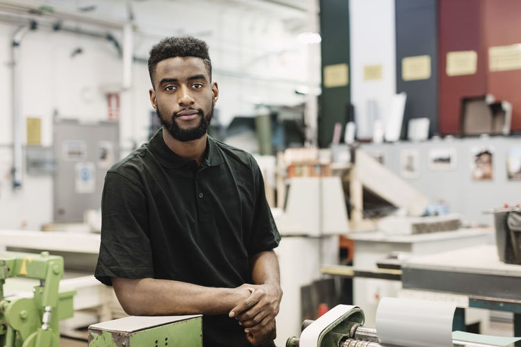 Portrait of confident male student in workshop