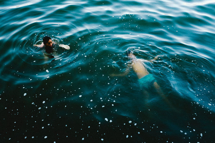People swimming in sea