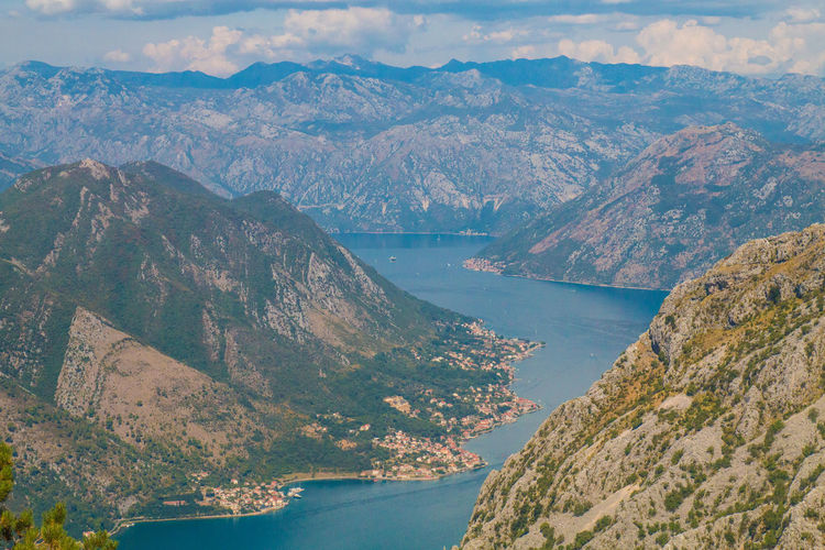 High angle view of sea and mountains against sky