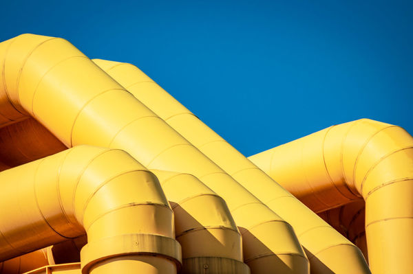 LOW ANGLE VIEW OF YELLOW PIPE AGAINST CLEAR SKY