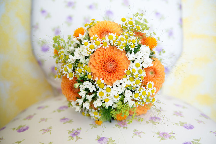 Close-up of flower bouquet on chair at wedding