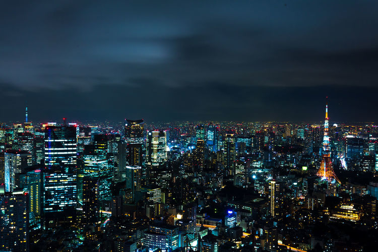 High angle view of illuminated city against sky at night