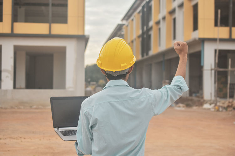 Rear view of man working